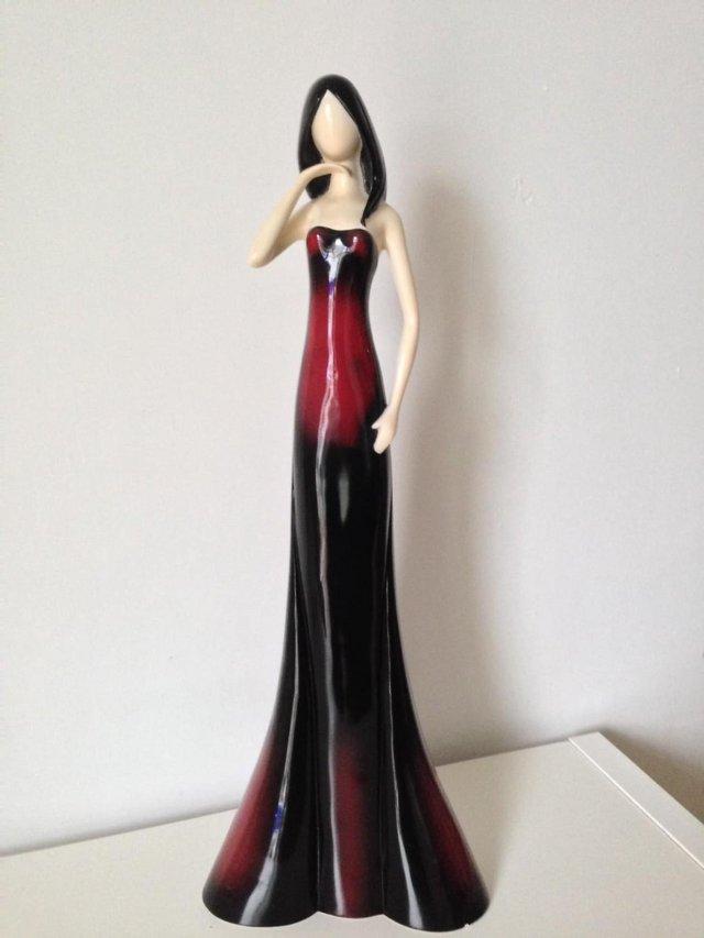 Preview of the first image of Leonardo Collection Tall Lady in Red.