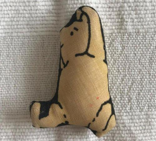 Image 1 of Tiny fabric Winnie the Pooh. Approx max 2” x 1½”