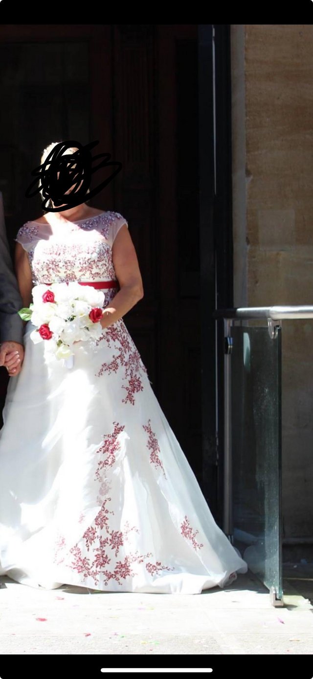 Preview of the first image of Ivory / ruby red diamontes full length wedding dress.