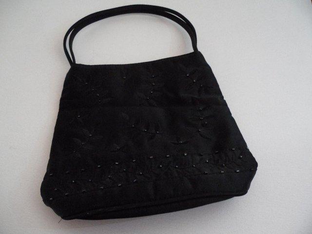 Preview of the first image of Black beaded evening bag with handles.
