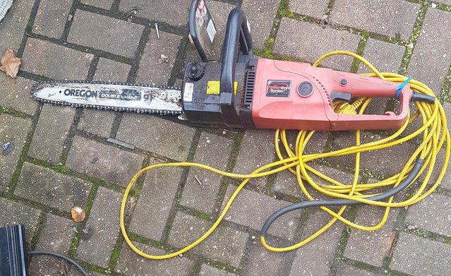 Image 1 of ELECTRIC CHAINSAW.  LONG 18 INCH BLADE AND LONG LEAD.