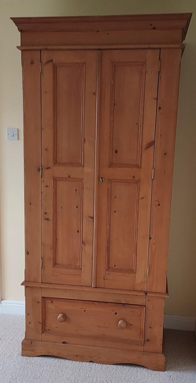 Preview of the first image of Pine wardrobe with hanging rails and spacious drawer.