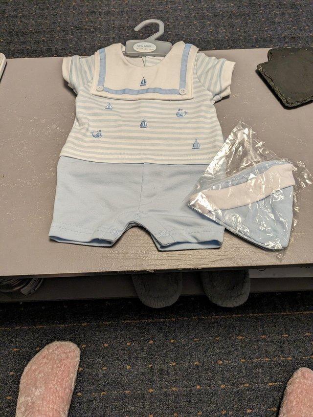 Preview of the first image of Baby boy shorts set with hat new never worn.