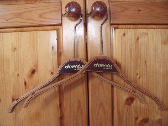 Preview of the first image of 2 vintage wood coat hangers Dereta of London. £8 both..
