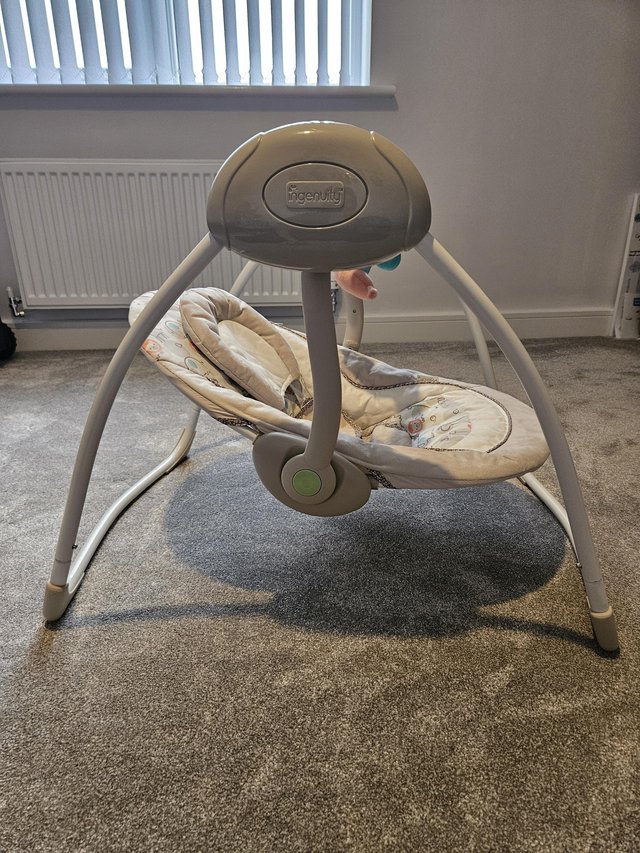 Preview of the first image of Ingenuity Baby Swing, plays music and swings.