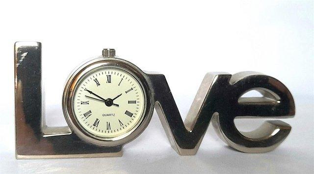 Preview of the first image of MINIATURE NOVELTY CLOCK - A " LOVE " SIGN.