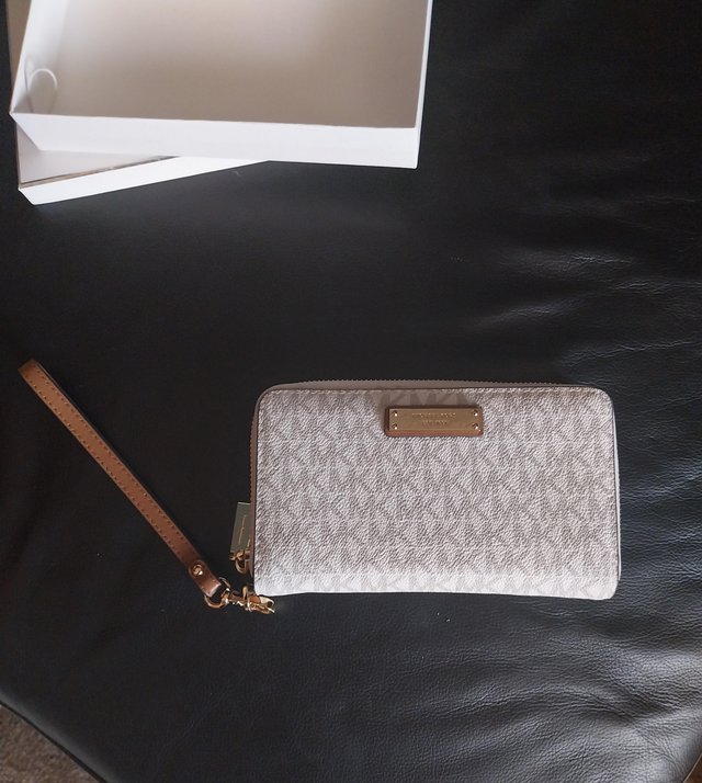 Preview of the first image of Michael Kors designer cream purse boxed like new.