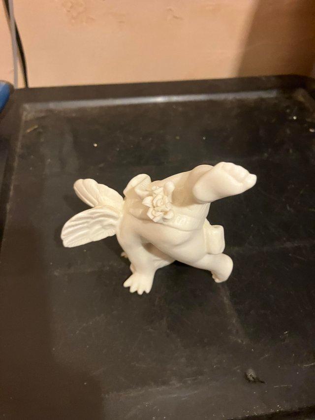 Preview of the first image of China figurine of a cartwheeling cherub.