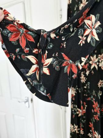 Image 2 of Black Floral Dress with Bell Sleeve.