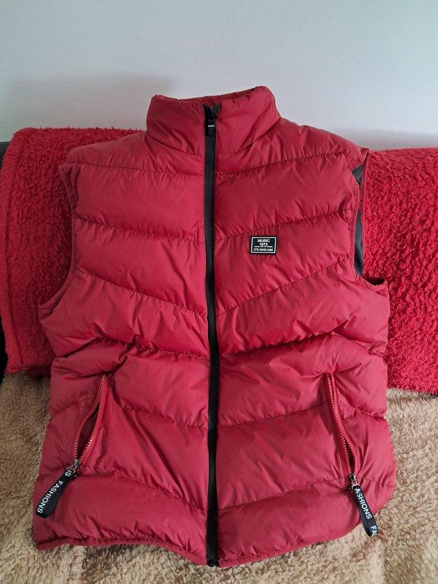Preview of the first image of Red vest puffer jacket with pockets.