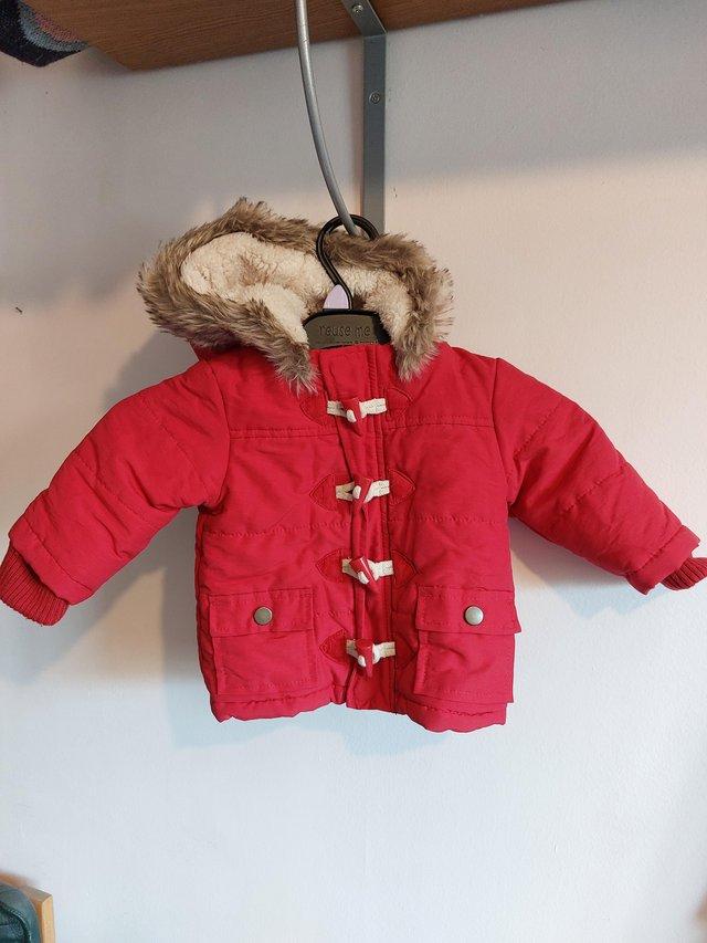 Preview of the first image of Red winter baby coat aged 3-6 months.