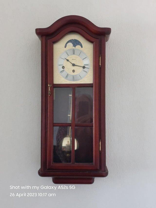 Preview of the first image of Wall clock. Mahogany finish working great.