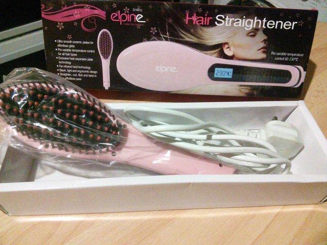Preview of the first image of Hair straightener brush with ceramic plates.
