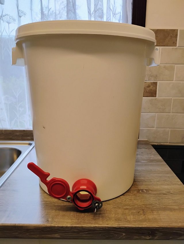 Preview of the first image of Two honey buckets with taps and stainless steel strainer.