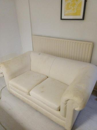 Image 1 of 2 seat sofa with cream covers.
