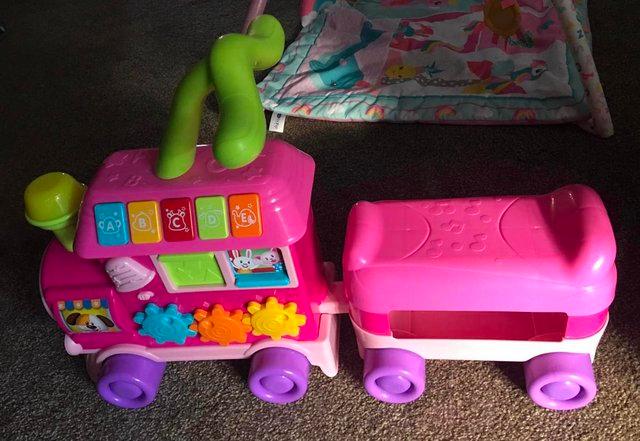 Preview of the first image of Pink Ride on / Baby Walker Train Interactive Toddler Toy.