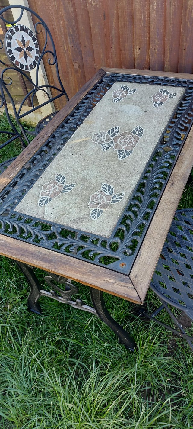 Preview of the first image of Heavy cast iron table and 4x chairs.