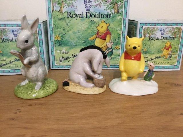 Preview of the first image of Three Royal Doulton Winnie the Pooh Collection figurines.