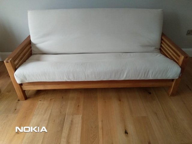 Preview of the first image of FUTON COMPANY - HORIZON - 3 SEATER SOFA BED SOLID OAK.