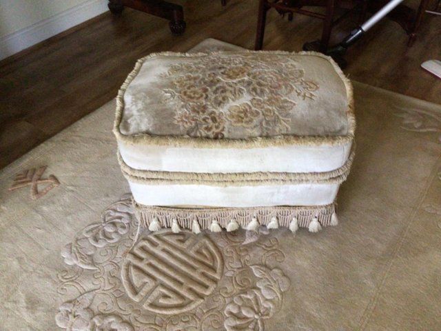 Preview of the first image of Beige Footstool, covered in patterned fabric.