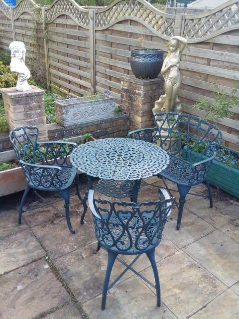 Preview of the first image of Heavy cast iron garden table with bench and two chairs.