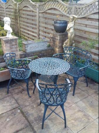 Image 1 of Heavy cast iron garden table with bench and two chairs