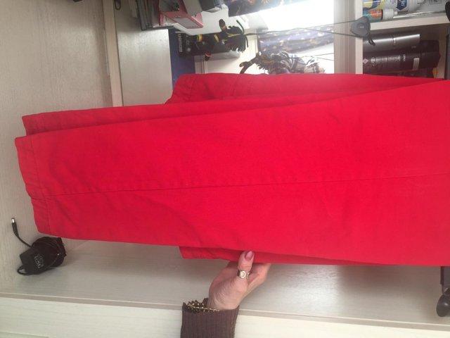 Preview of the first image of Ladies Jacket and red trousers.