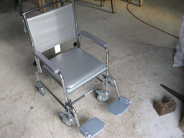 Preview of the first image of Portable commode doubles as a transfer chair.