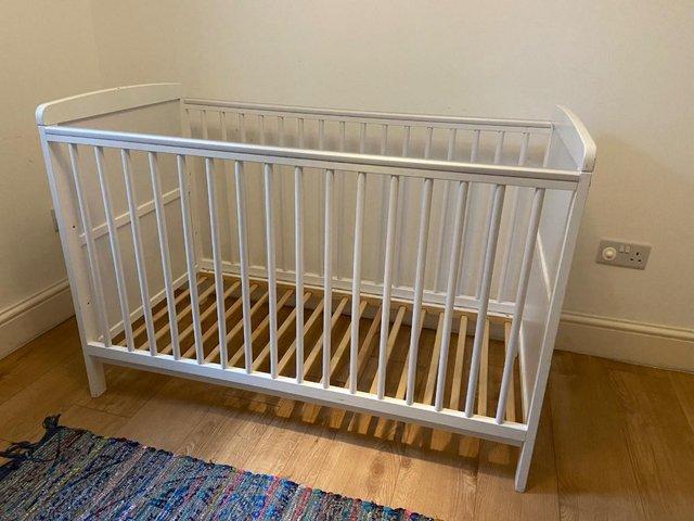 Preview of the first image of ARGOS Adjustable White Cot with Teething Rail.
