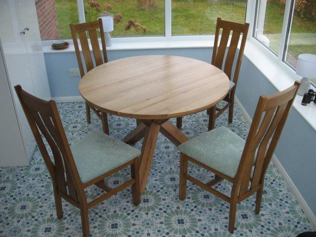 Preview of the first image of OAK FURNITURE LAND CIRCULAR OAK DINING TABLE AND FOUR CHAIRS.