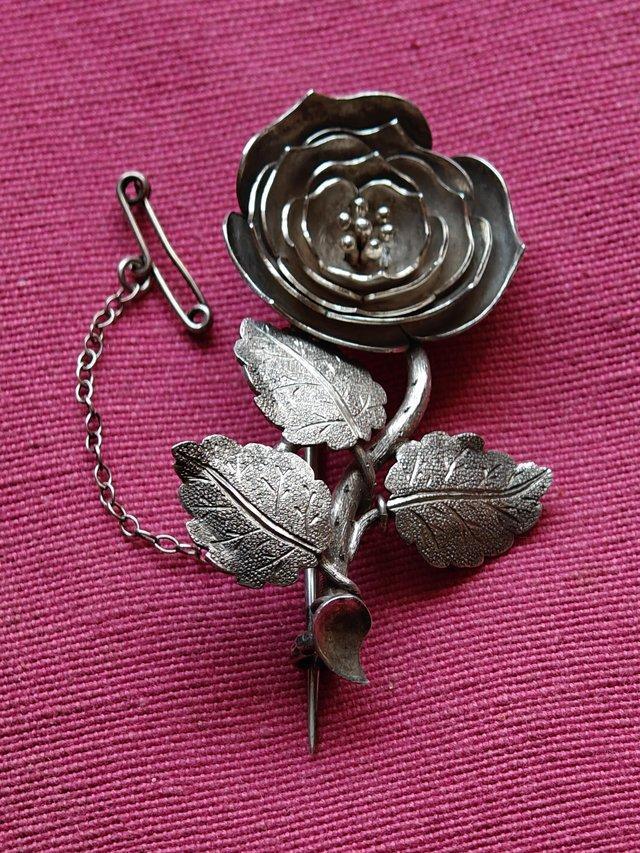 Preview of the first image of Vintage White Metal Flower Brooch.