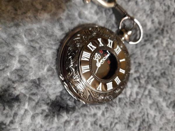 Image 2 of black pocket watch with goth type chain.