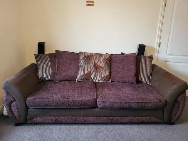 Preview of the first image of DFS Brown sofa with silver/duck egg trimmed cushions.