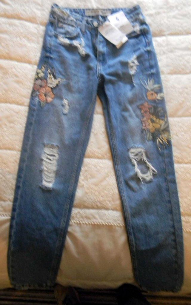 Preview of the first image of NEW GIRLS EMBROIDERED FADED RIPPED FADED JEANS.