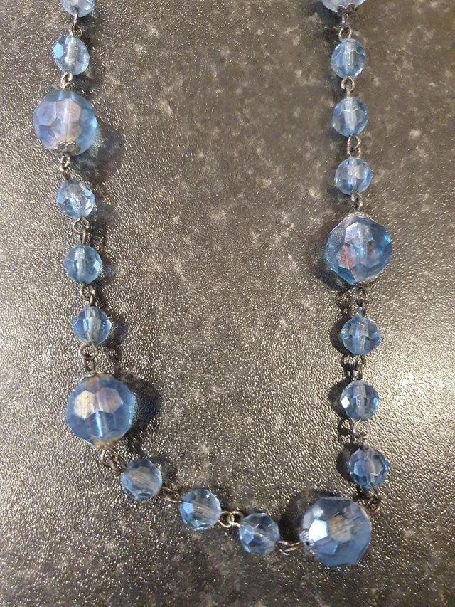 Preview of the first image of Topshop long blue opaque beaded necklace.