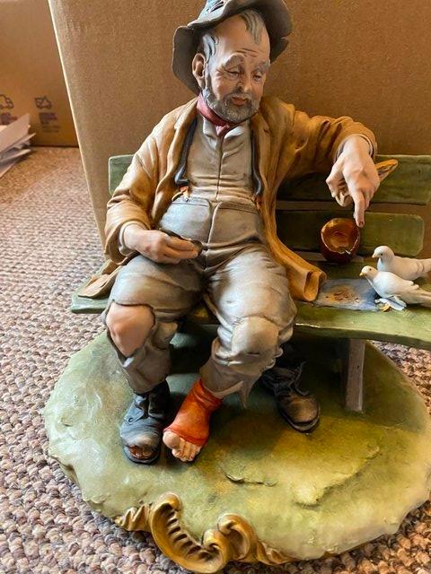Preview of the first image of Rare Vintage CapoDimonte Figure of Tramp on a bench.