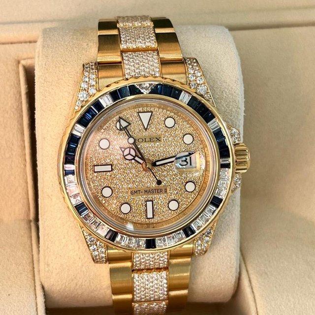 Preview of the first image of Rolex GMT Master II 116758 SA Mens yellow gold diamond watch.