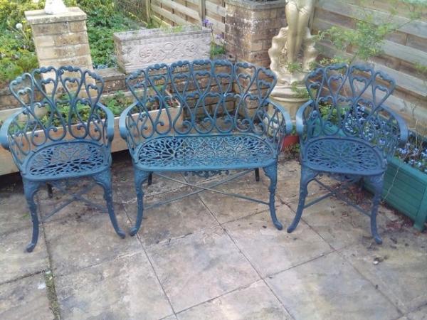 Image 6 of Heavy cast iron garden table with bench and two chairs