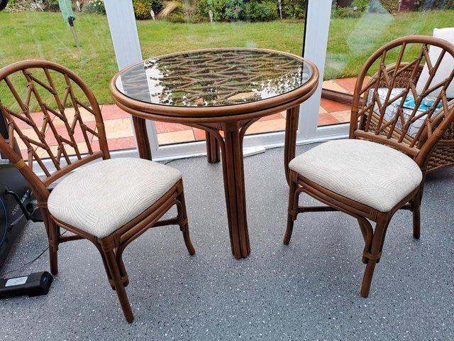 Preview of the first image of Round cane table and two chairs.
