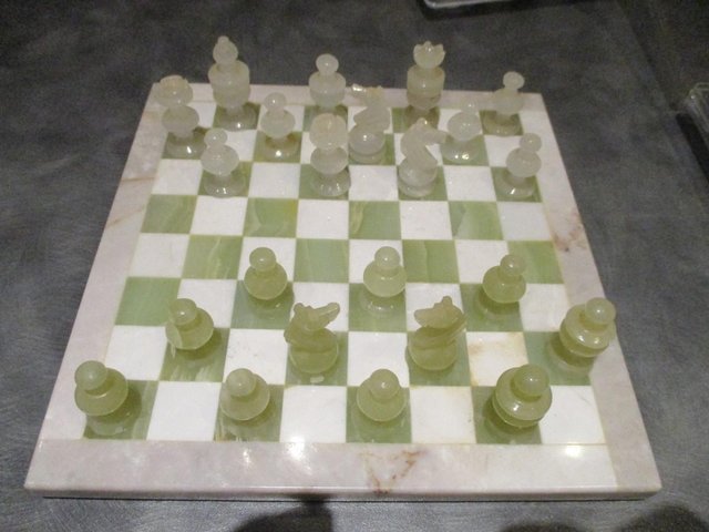 Preview of the first image of Marble chess board with 2 x 16 chess pieces.