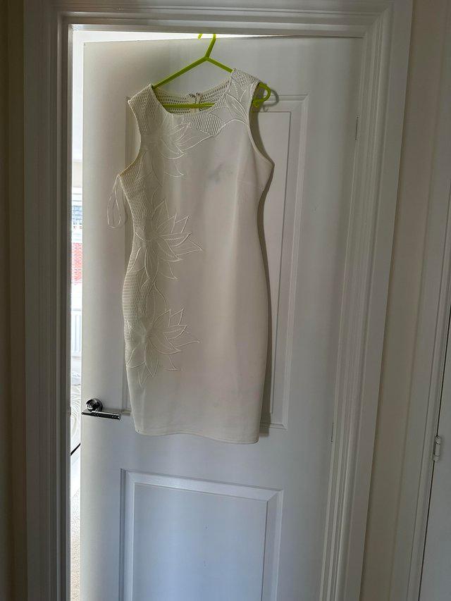 Preview of the first image of Lipsy white dress flower detail.