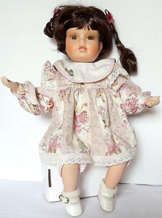 Preview of the first image of KELLY A PORCELAIN DOLL - WHITE FLORAL DRESS 33 cm.