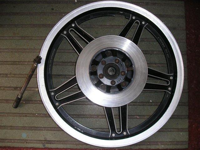 Preview of the first image of HONDA CX 500 WHEEL ALONG WITH DISCS AND WHEEL SPINDLE.