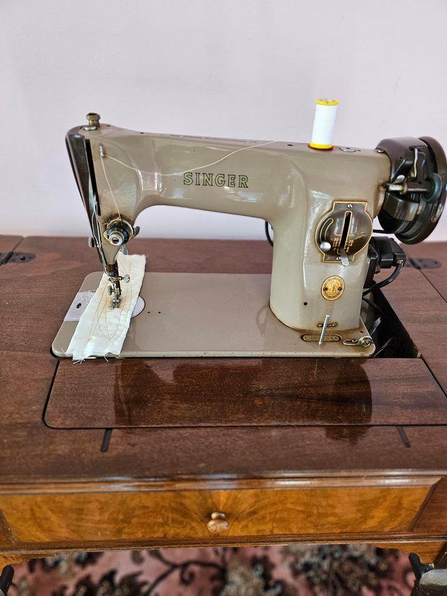 Preview of the first image of Singer 201Ksewing machine complete with table and power lead.