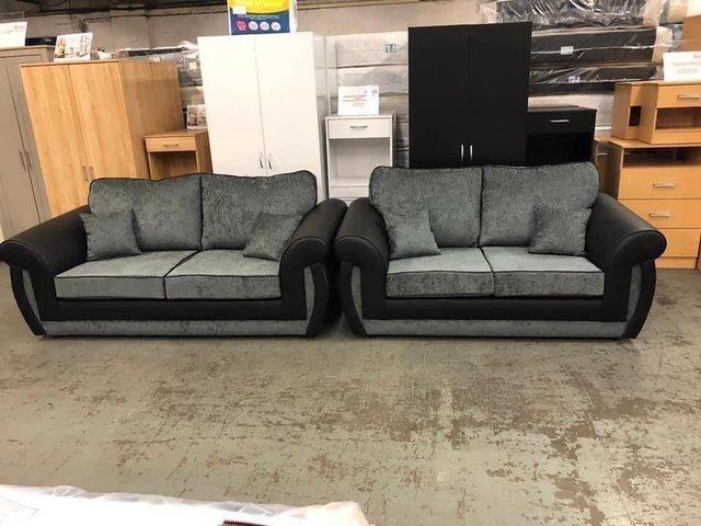 Preview of the first image of Phoenix 3&2 sofas in black pu and grey Carlton fabric.
