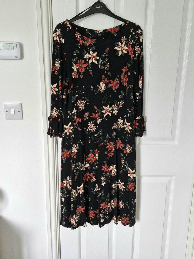 Preview of the first image of Black Floral Dress with Bell Sleeve..