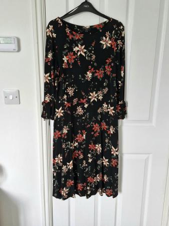 Image 1 of Black Floral Dress with Bell Sleeve.