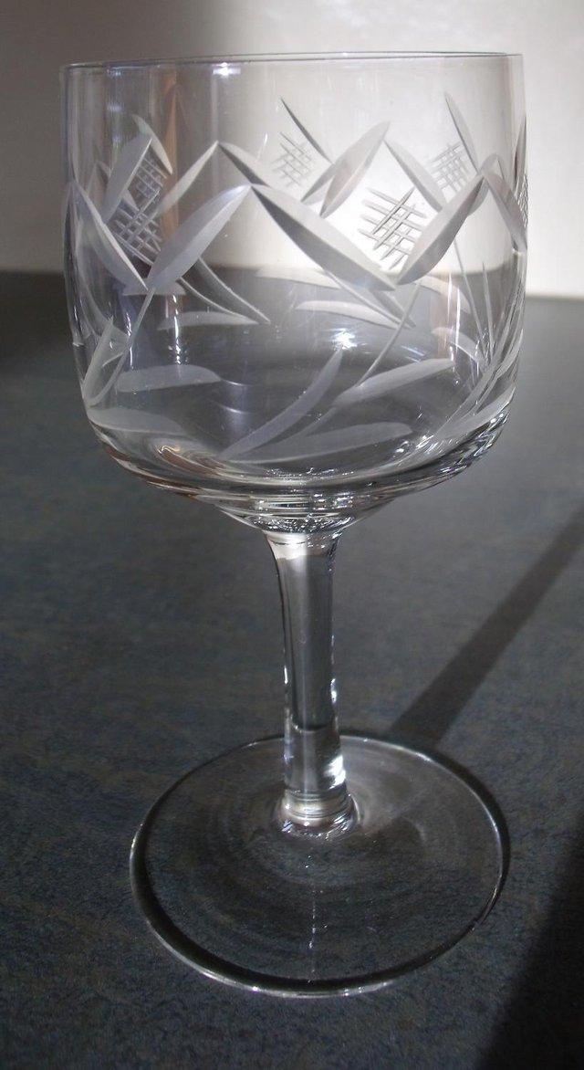 Preview of the first image of Vintage wine glass with etched stylised leaf/flower design.