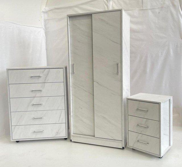 Preview of the first image of AERO WHITE STONE EFFECT SLIDING WARDROBE CHEST AND BEDSIDE.