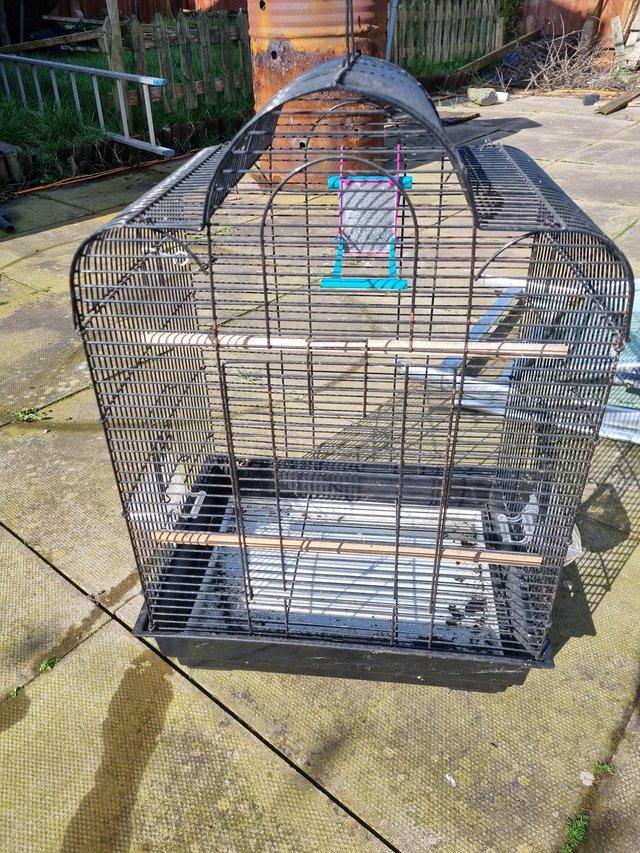 Preview of the first image of 2 bird cages 1 large 1 small need cleaning both good..